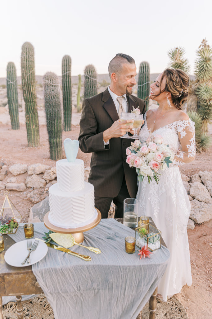 cake cutting with white cake and cactus topper