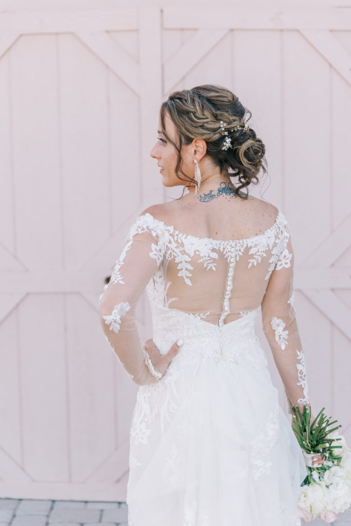 the back of the bride's dress and braided updo.