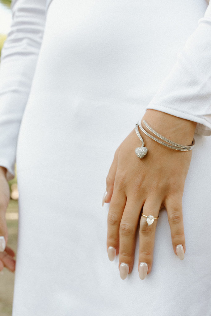 close up of bride's left hand with pear shaped ring