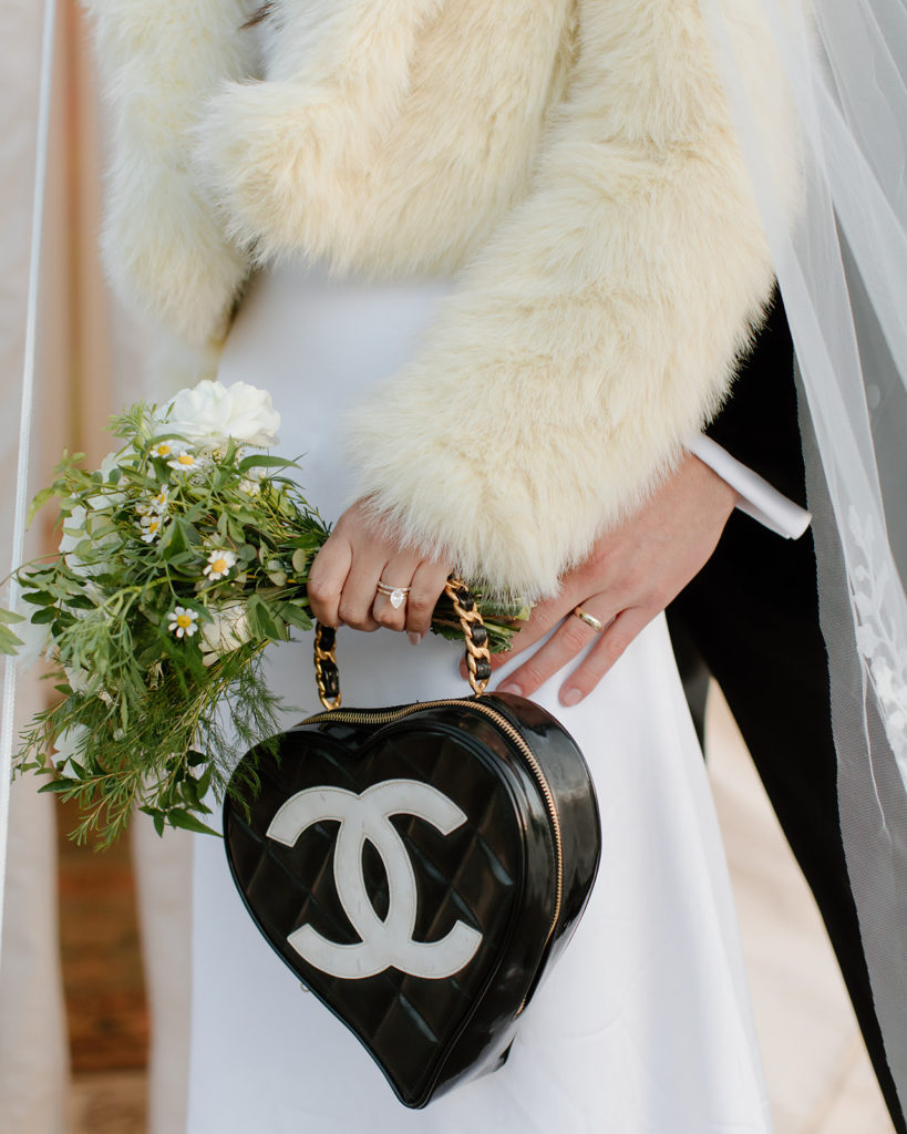 boujee chanel bag carried in hands of bride
