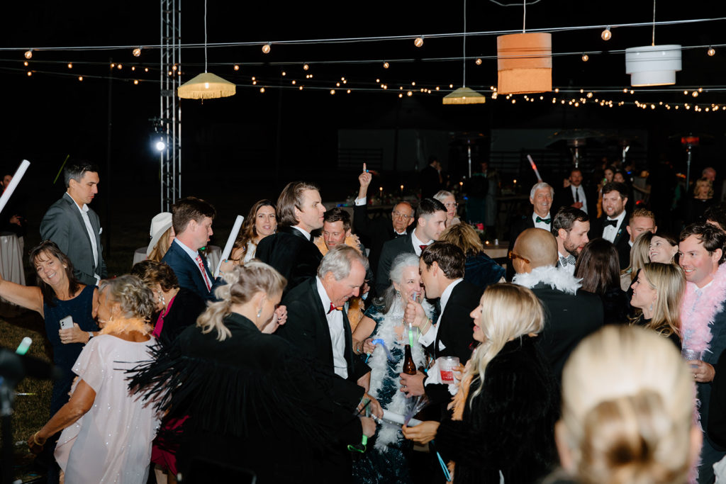 guests partying on dance floor with string lights