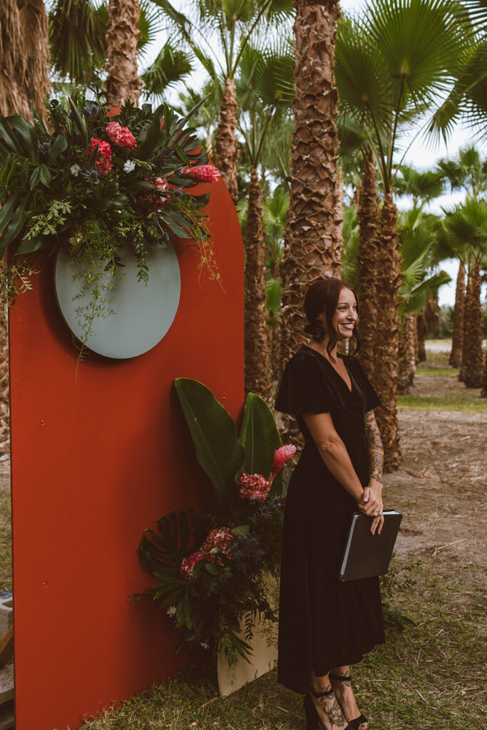 officiant stands at boho tropical altar produced by P3 Events elopement coordination package